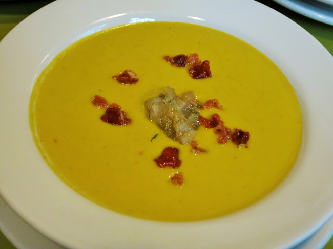 Roasted pumpkin and fennel soup, garnished with pear-fennel compote and crispy Serrano ham.