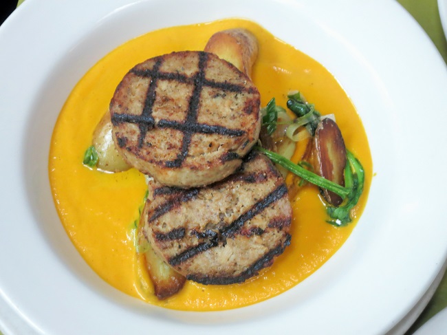 Grilled rabbit-pork boudin sausage served on a sauté of fingerling potatoes, Walla Walla onions and spinach and butter-roasted carrot purée