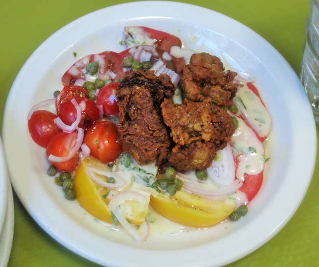 Salad of local tomatoes, shallots, capers, and tarragon-garlic vinaigrette, and if you choose, with buttermilk fried chicken livers 