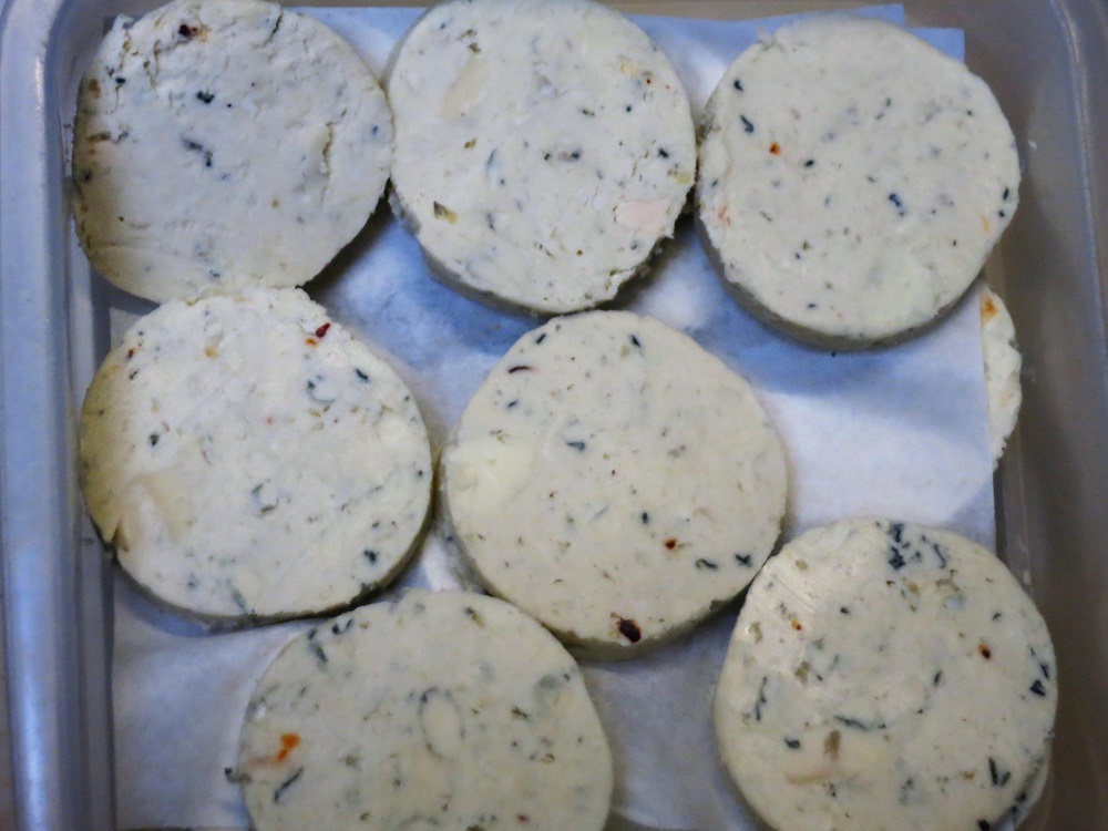 Rounds of compound butter made with Bleu d'Auvergne cheese are ready to garnish our petit sirloin steak frites