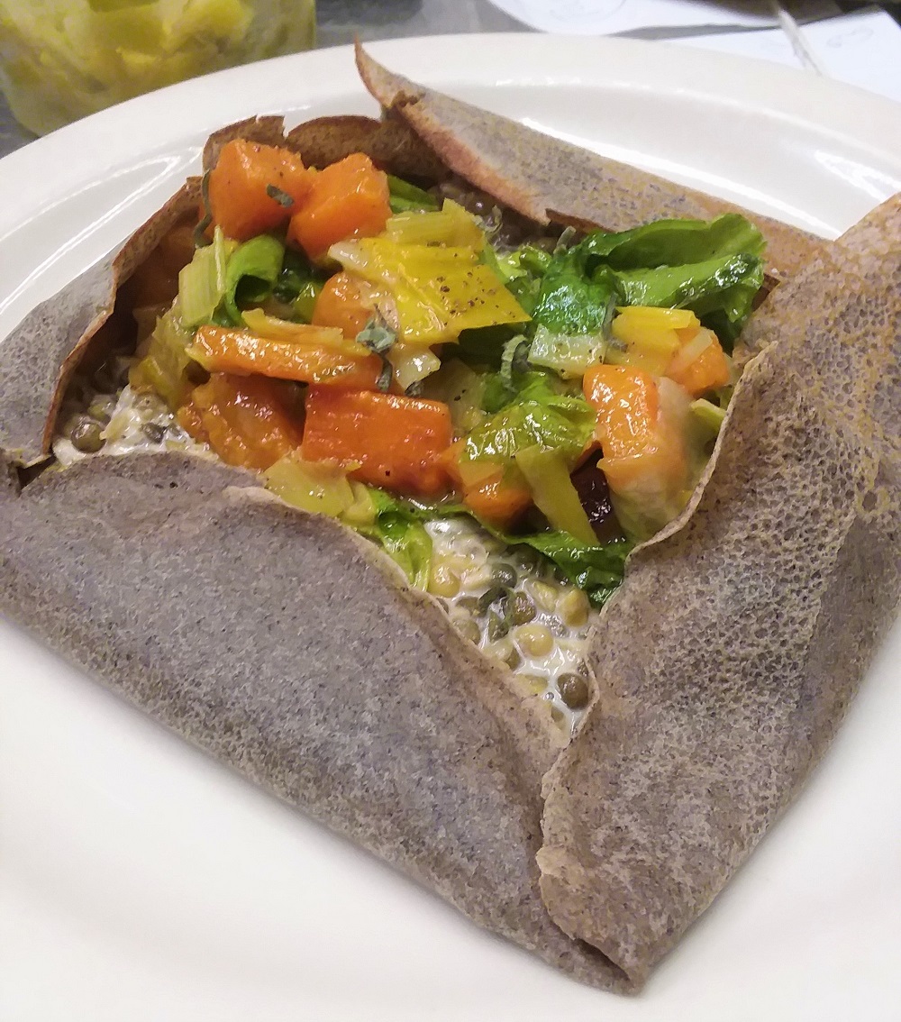 Buckwheat crepe filled with lentils simmered with cream and white wine, topped with a sauté of leeks, escarole and butternut squash